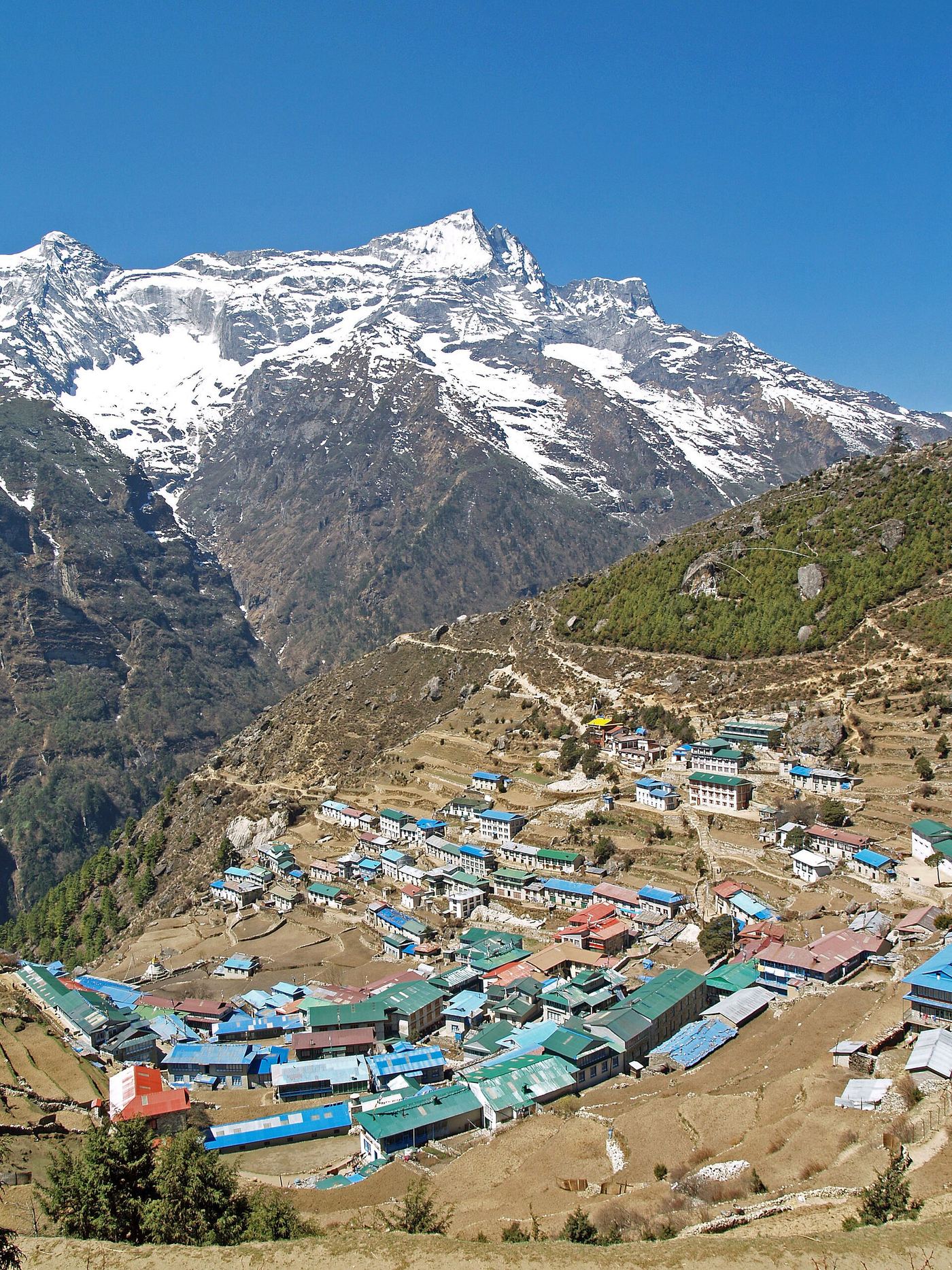 Namche Bazaar village located at 3,440 metres (11,286 ft) above the sea level in  Khumbu region, northeastern Nepal. The Kongde Ri peak with its 6,187 m (20,299